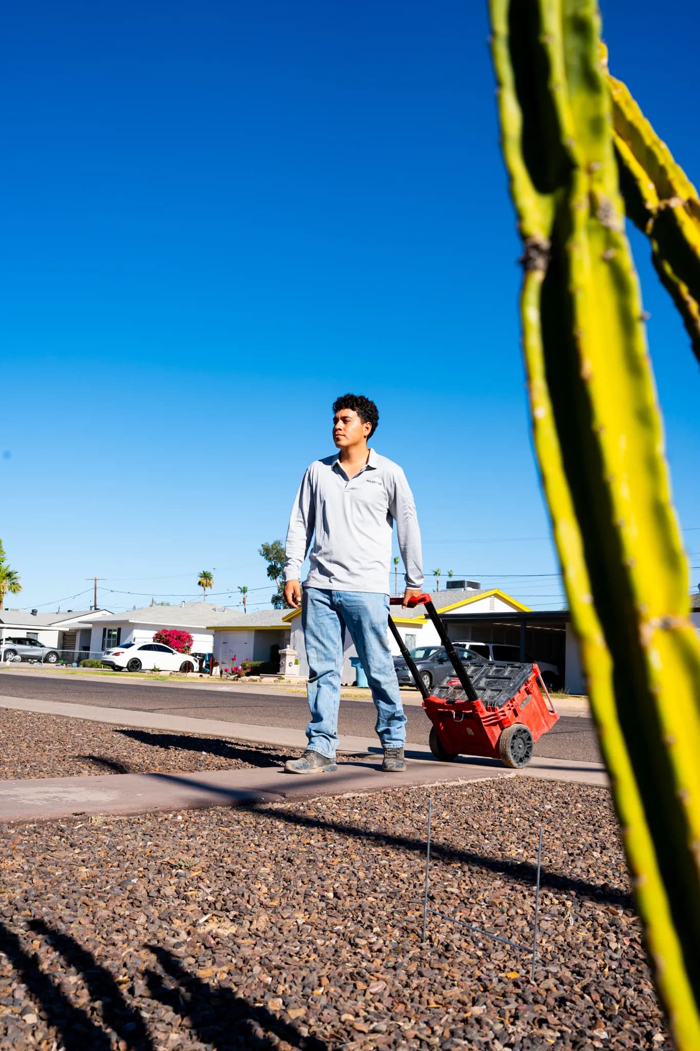 Warriors Plumbing & Rooter technician arriving at a Phoenix home with a drain machine
