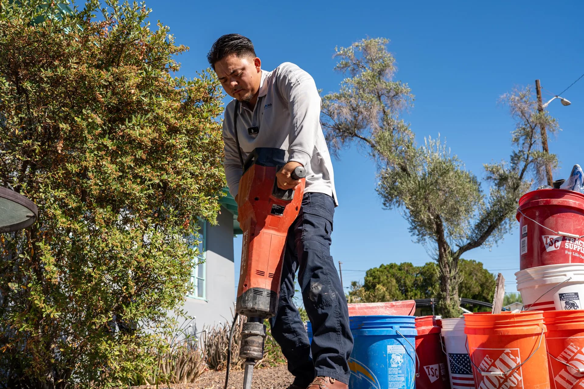 Warriors Plumbing & Rooter technician breaking ground for a sewer line in Phoenix