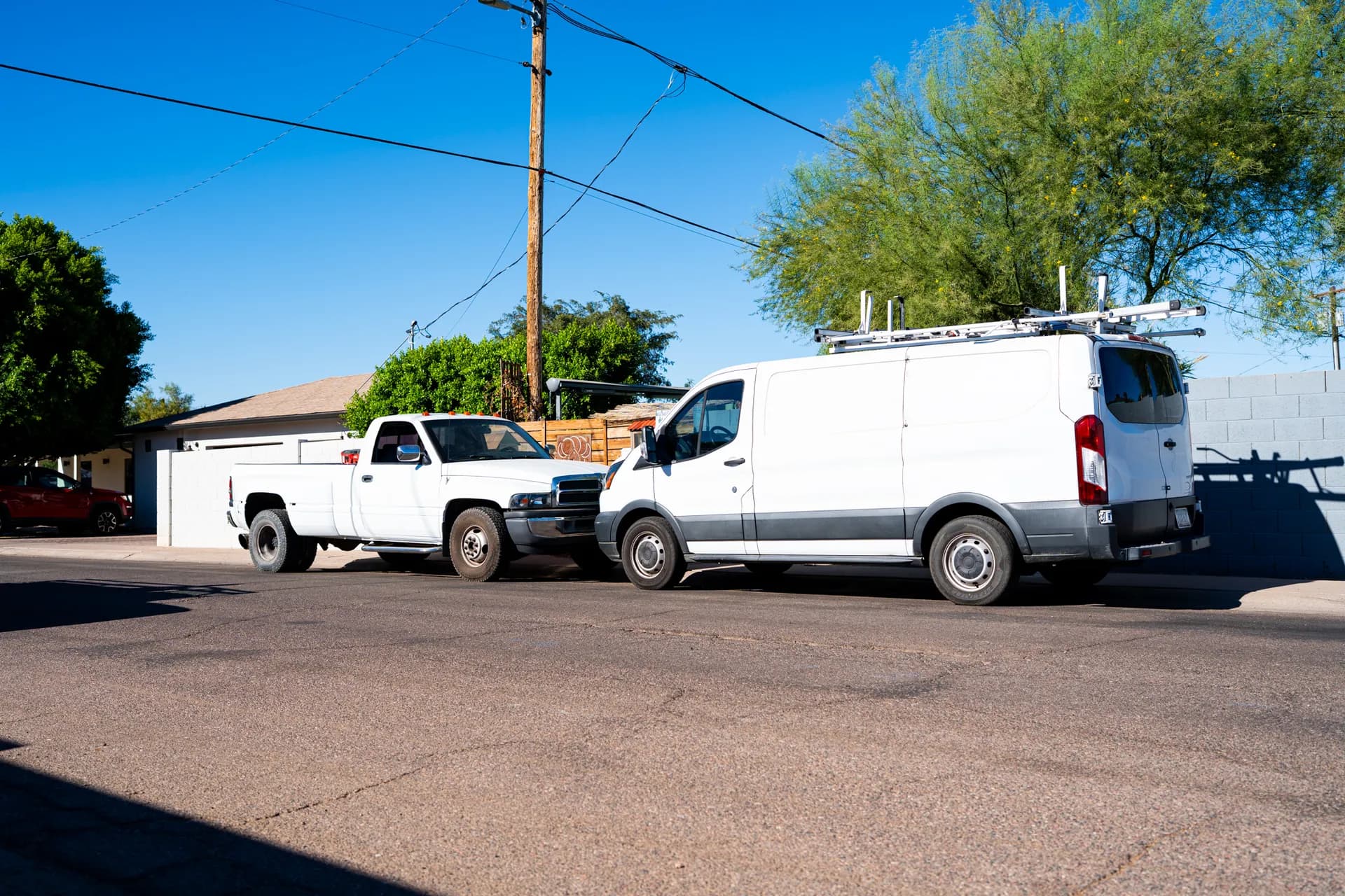 Warriors Plumbing & Rooter service vans parked on a Phoenix neighborhood street